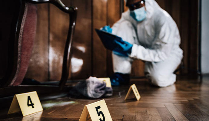 Forensic specialist documenting evidence at crime scene Forensic specialist documenting evidence at crime scene