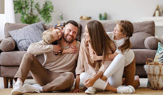 Happy family enjoying quality times in living room Happy family enjoying quality times in living room