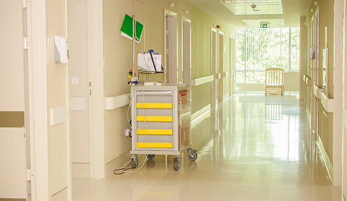 Clean hospital hallway with medical emergency cart