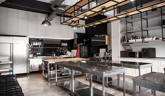 Modern commercial kitchen with stainless steel workstations