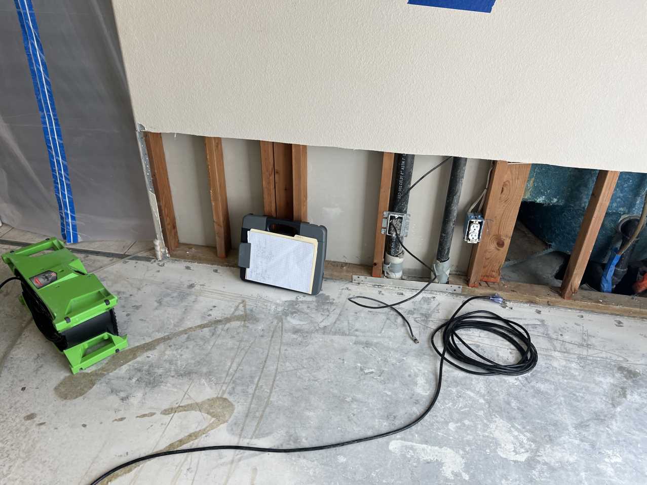 Finished master bedroom restoration following a wall leak, showing successfully repaired walls and new water damage restoration flooring after comprehensive structural drying and mitigation.