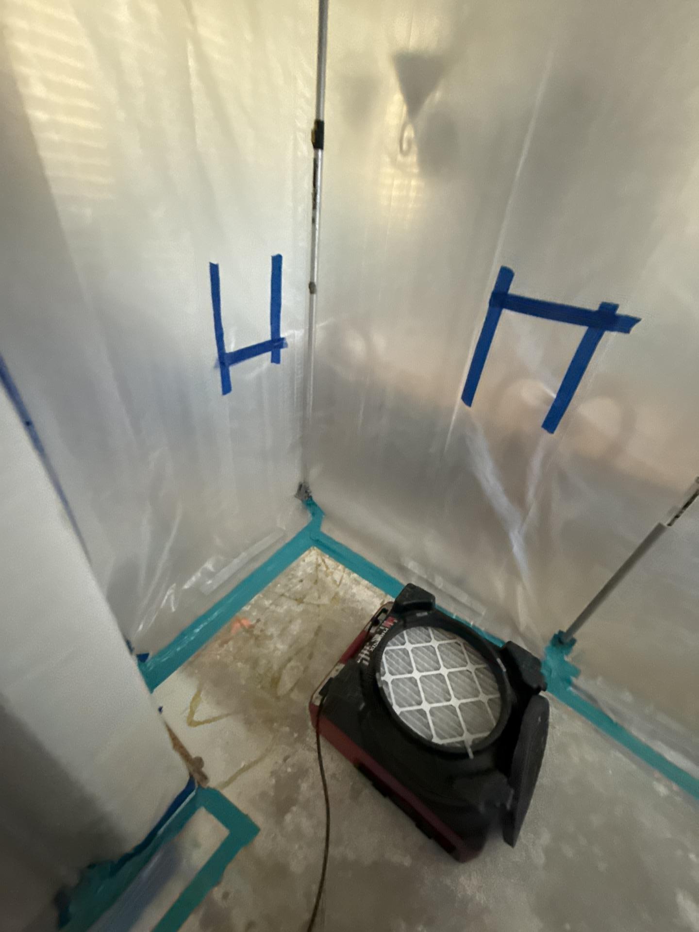 Water mitigation containment chamber using an air scrubber to filter the air during structural drying, a vital step for mold prevention and effective property restoration after significant water intrusion.