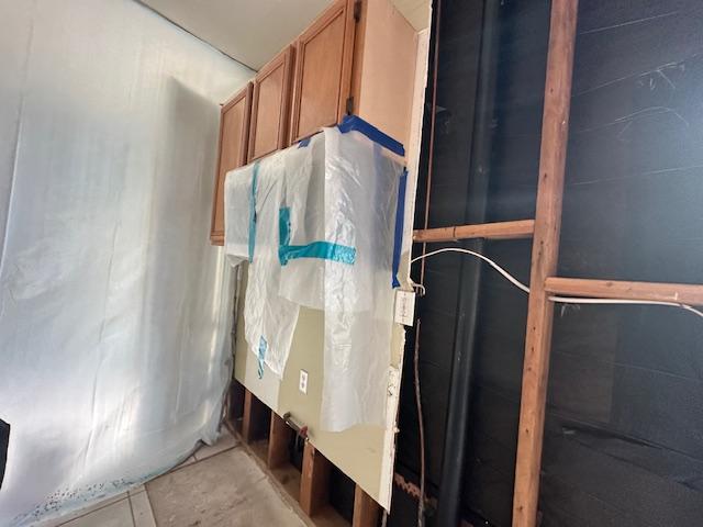 Kitchen cabinets protected during wall and flooring restoration after an upstairs toilet leak. dkirestotech specializes in kitchen water damage repair, ceiling repair, and cabinet restoration.
