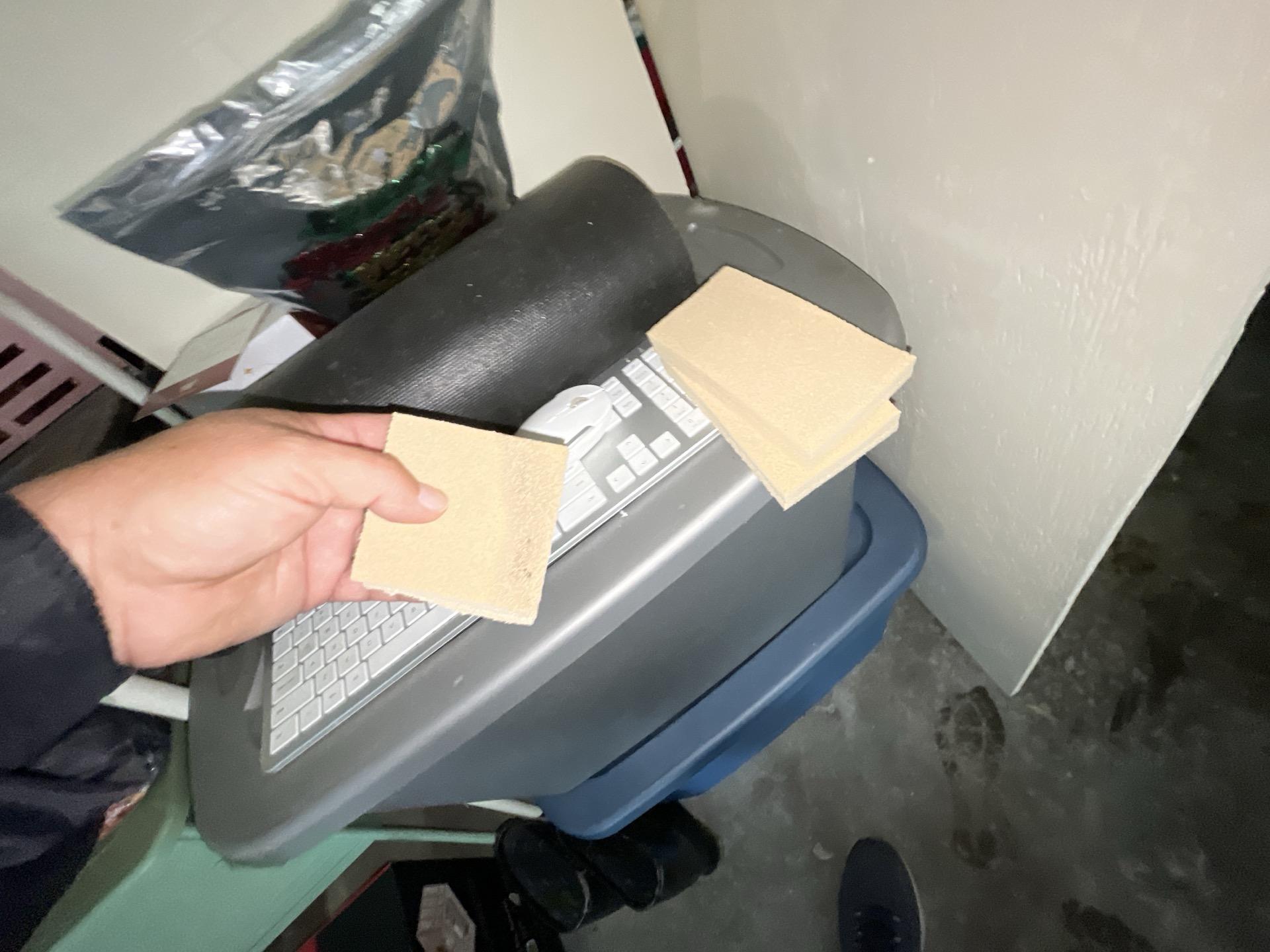 Assessing smoke and soot damage on personal items and electronics using a test sponge, a critical step in contents cleaning and comprehensive fire damage restoration services.