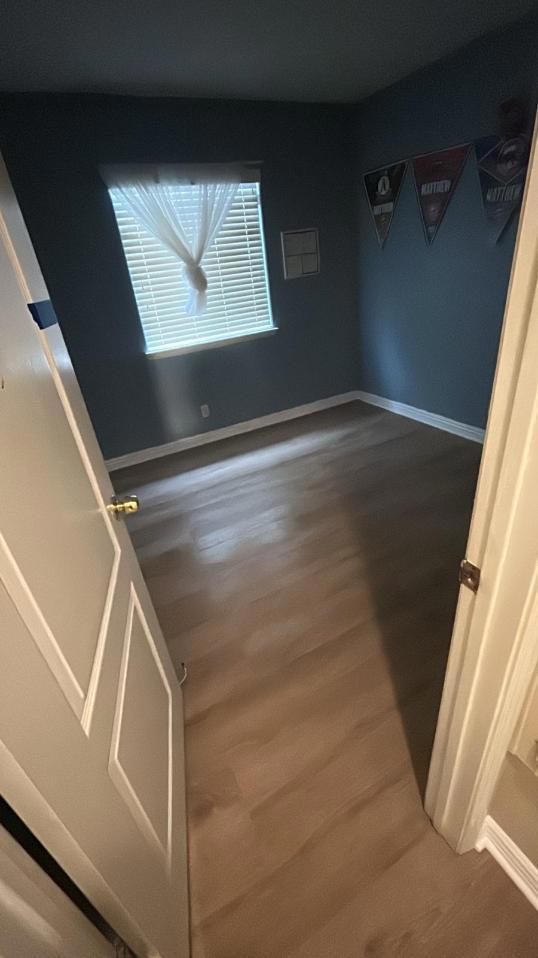 Successfully completed water damage restoration in a bedroom, featuring the new luxury vinyl flooring restoration and full structural drying after water mitigation services.