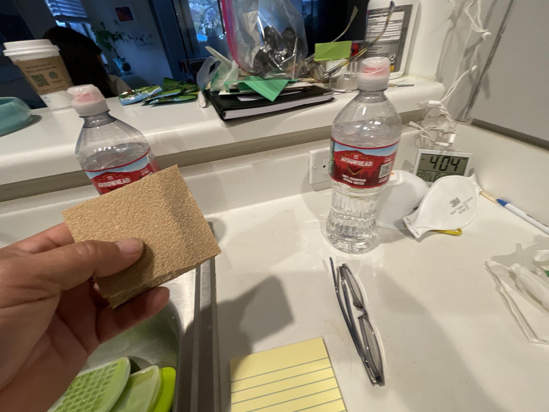 A technician performing a test on kitchen surfaces to determine the extent of smoke and soot residue for effective fire damage cleanup and complete property deodorization services.