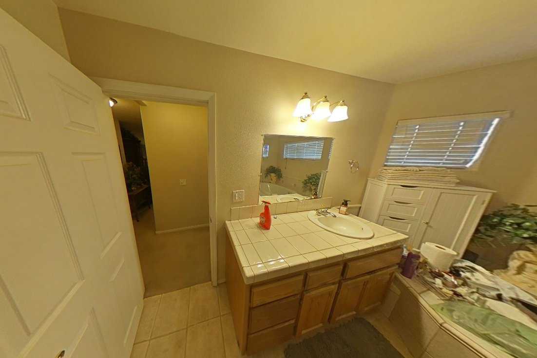 Bathroom fire damage cleanup with focus on soot and smoke residue removal from vanity, tiles, and walls, ensuring complete deodorization and property restoration.