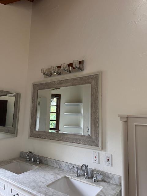 Final restoration of the bathroom vanity area after smoke damage, showing professional soot cleanup of walls, mirrors, and fixtures, achieving full odor removal and excellent air quality.