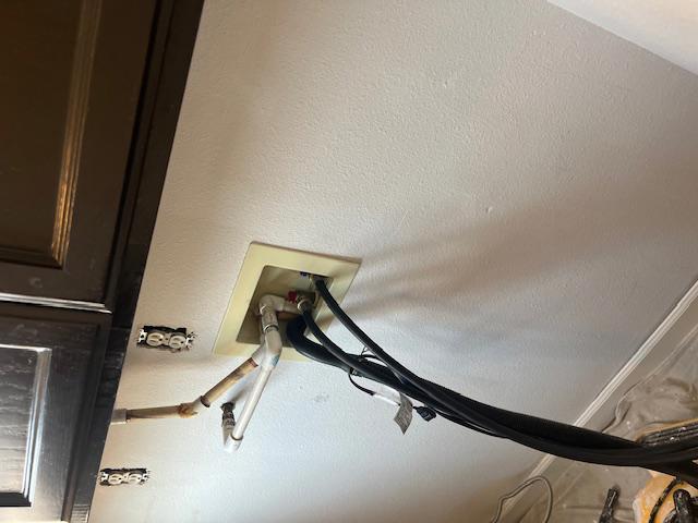 Detailed fire damage cleanup of the appliance hookup area, ensuring all surfaces and utilities are free from soot and smoke residue as part of comprehensive property restoration services.