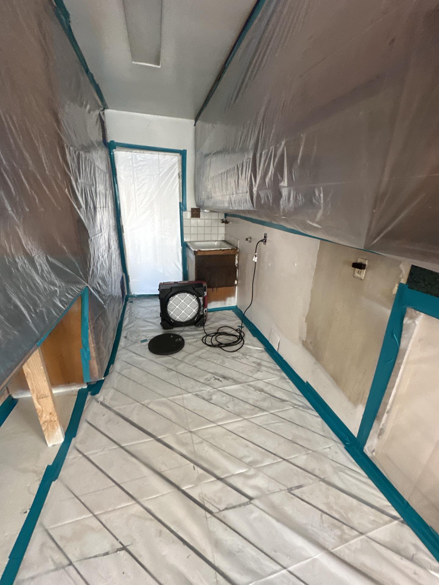 Interior view of a containment chamber set up for emergency water mitigation, showing specialized equipment used for targeted structural drying and dehumidification to achieve fast and effective property restoration.