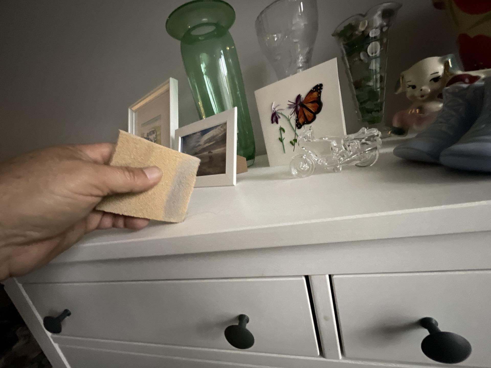 Checking soot and smoke residue on bedroom furniture and personal items for detailed contents cleaning and complete fire damage restoration of the property's contents.